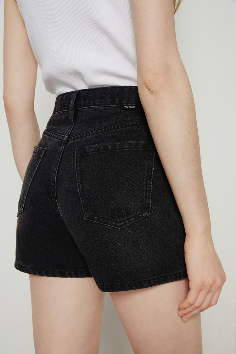 Hey Joanie Boyish Vintage High Rise Shorts in denim, showcasing a classic high waist and relaxed fit on a model.