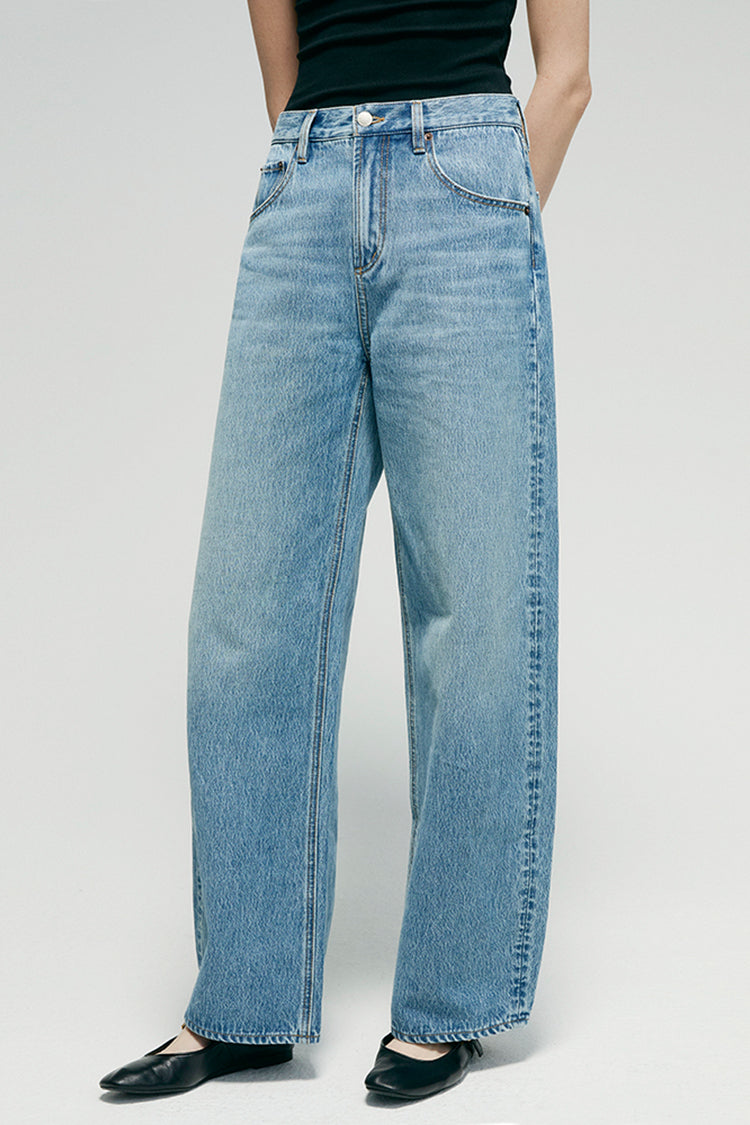 Hey Joanie Slope Curve Jeans HJ039 with high-rise fit, classic blue denim, and curved leg design, displayed on a hanger.