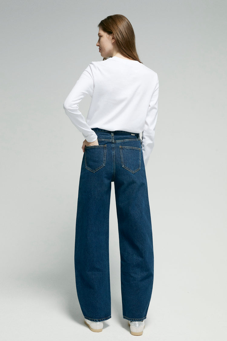 Hey Joanie Slope Curve Jeans HJ039 with classic five-pocket design and light wash denim, displayed on a hanger.