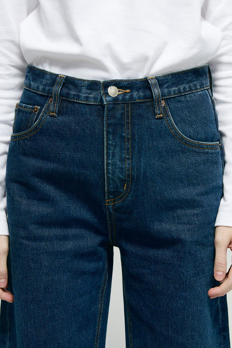 Hey Joanie Slope Curve Jeans HJ039 in dark wash denim, showing a close-up of the textured fabric and classic jean stitching.