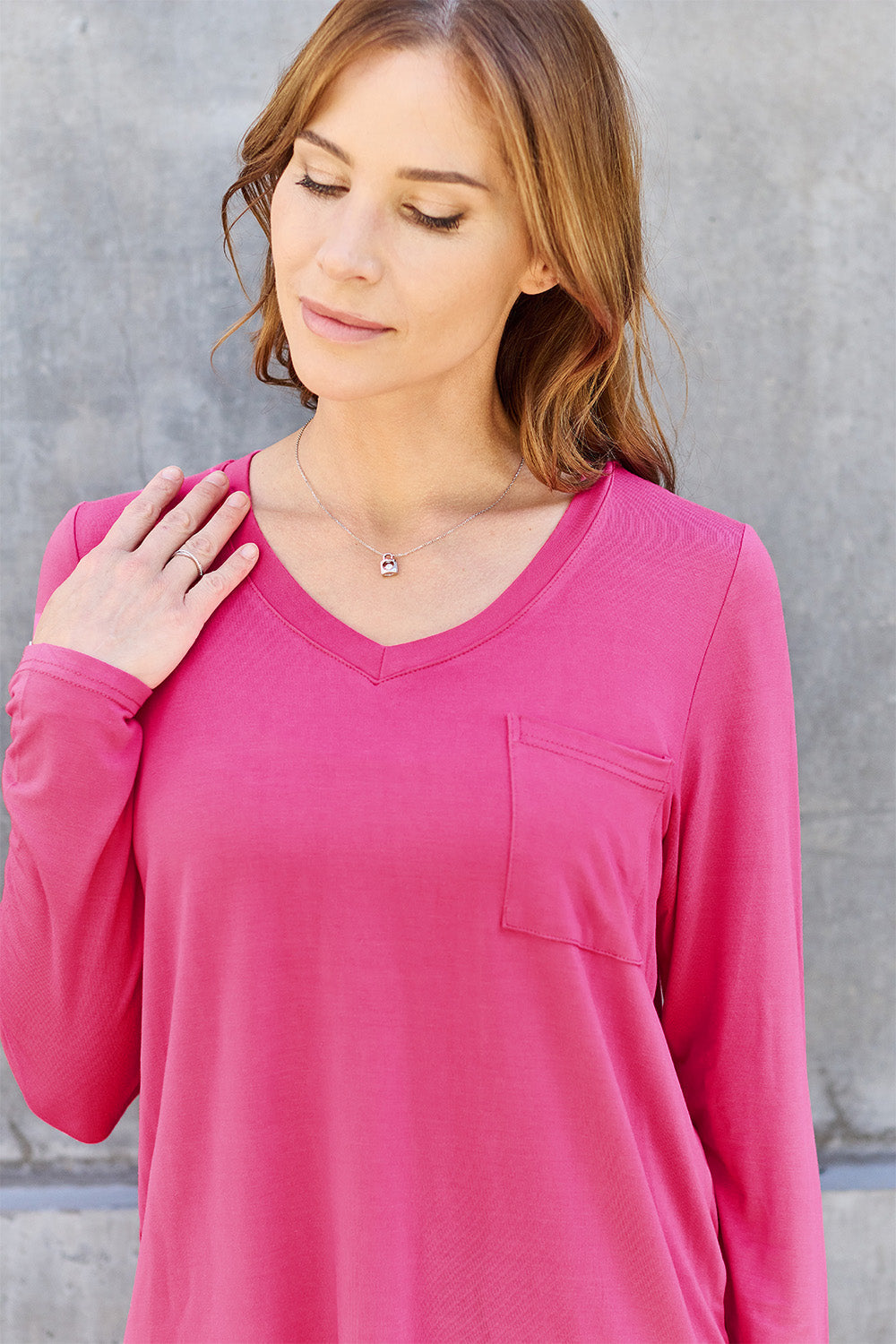 Basic Bae full size V-neck long sleeve top in solid color, featuring a relaxed fit and soft fabric for casual wear.