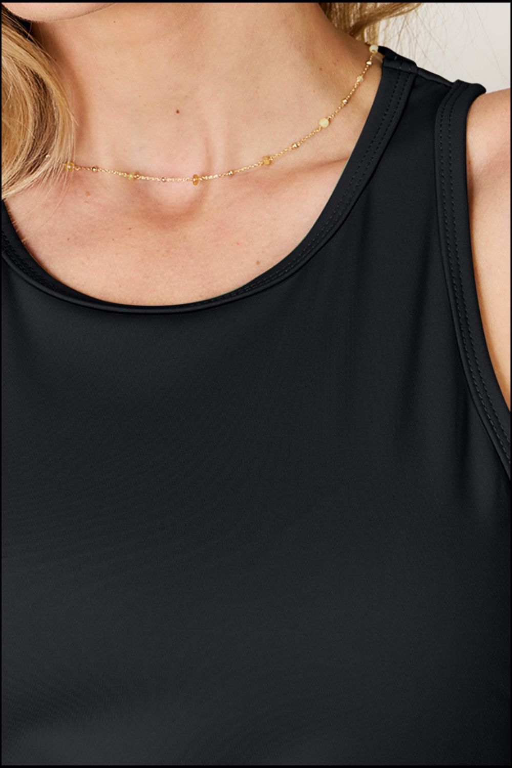 ShopBasicbae Basic Bae full size round neck racerback tank top, showing the casual fit and smooth fabric in a neutral color.