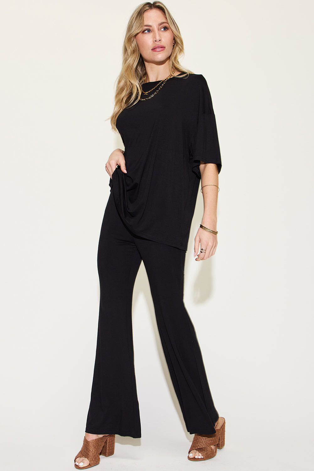 ShopBasicbae bamboo drop shoulder T-shirt and flare pants set displayed on a model, showcasing casual, comfortable loungewear style.