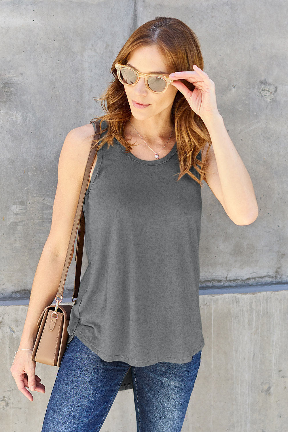 ShopBasicbae Basic Bae full-size round neck curved hem tank top, casual sleeveless top with comfortable fit and stylish design.