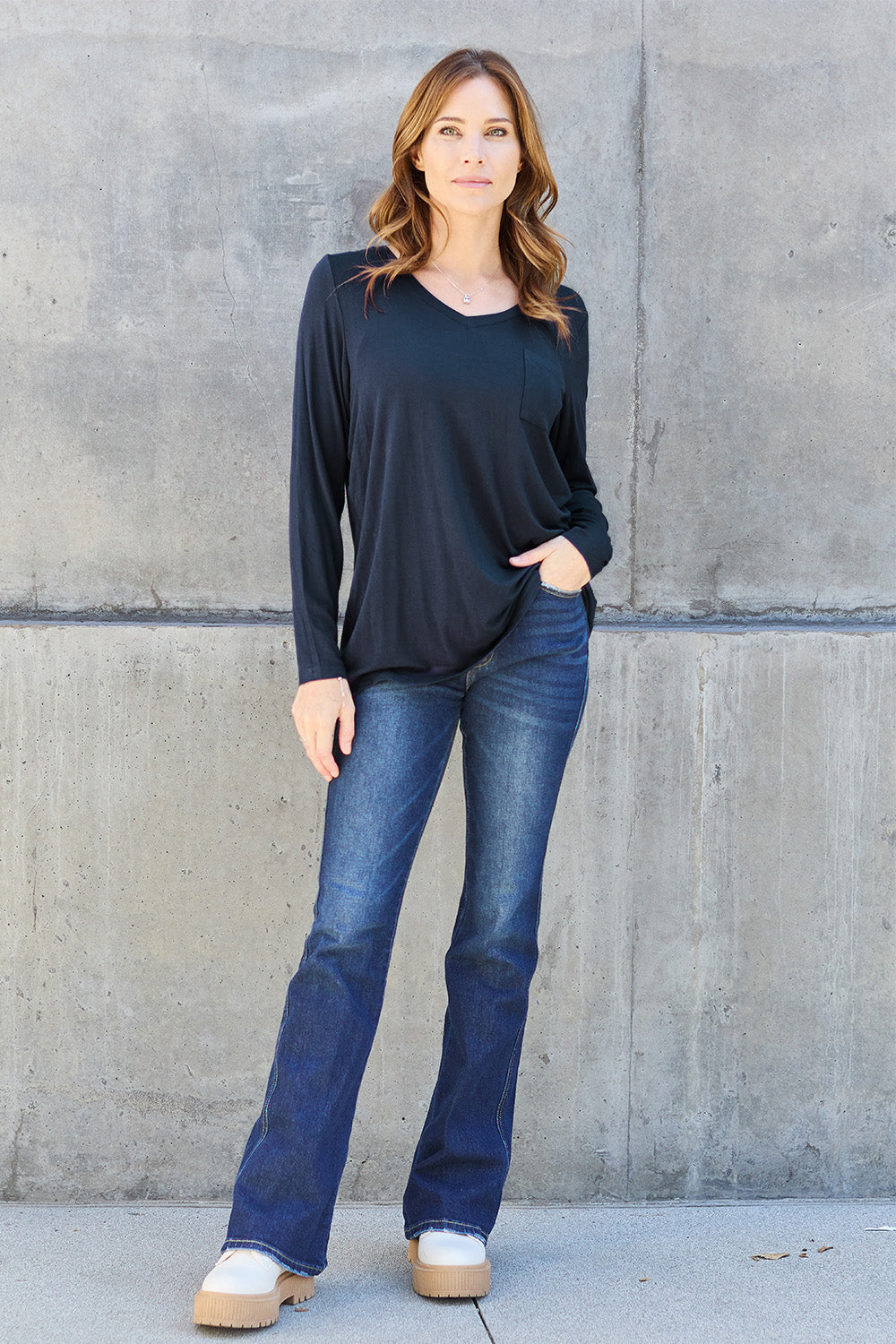 ShopBasicbae Basic Bae full-size V-neck long sleeve top in soft fabric, shown on a hanger with a simple, classic design.