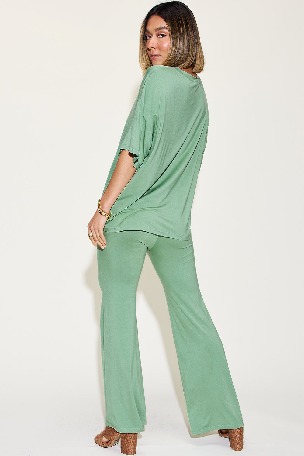 Basic Bae bamboo drop shoulder T-shirt and flare pants set, showing light green fabric, relaxed fit, and casual style.