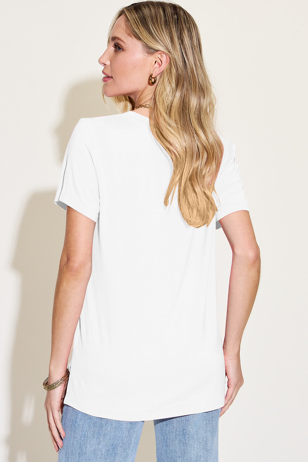 ShopBasicbae Basic Bae bamboo full-size V-neck high-low T-shirt, beige color, soft fabric, displayed on a hanger.