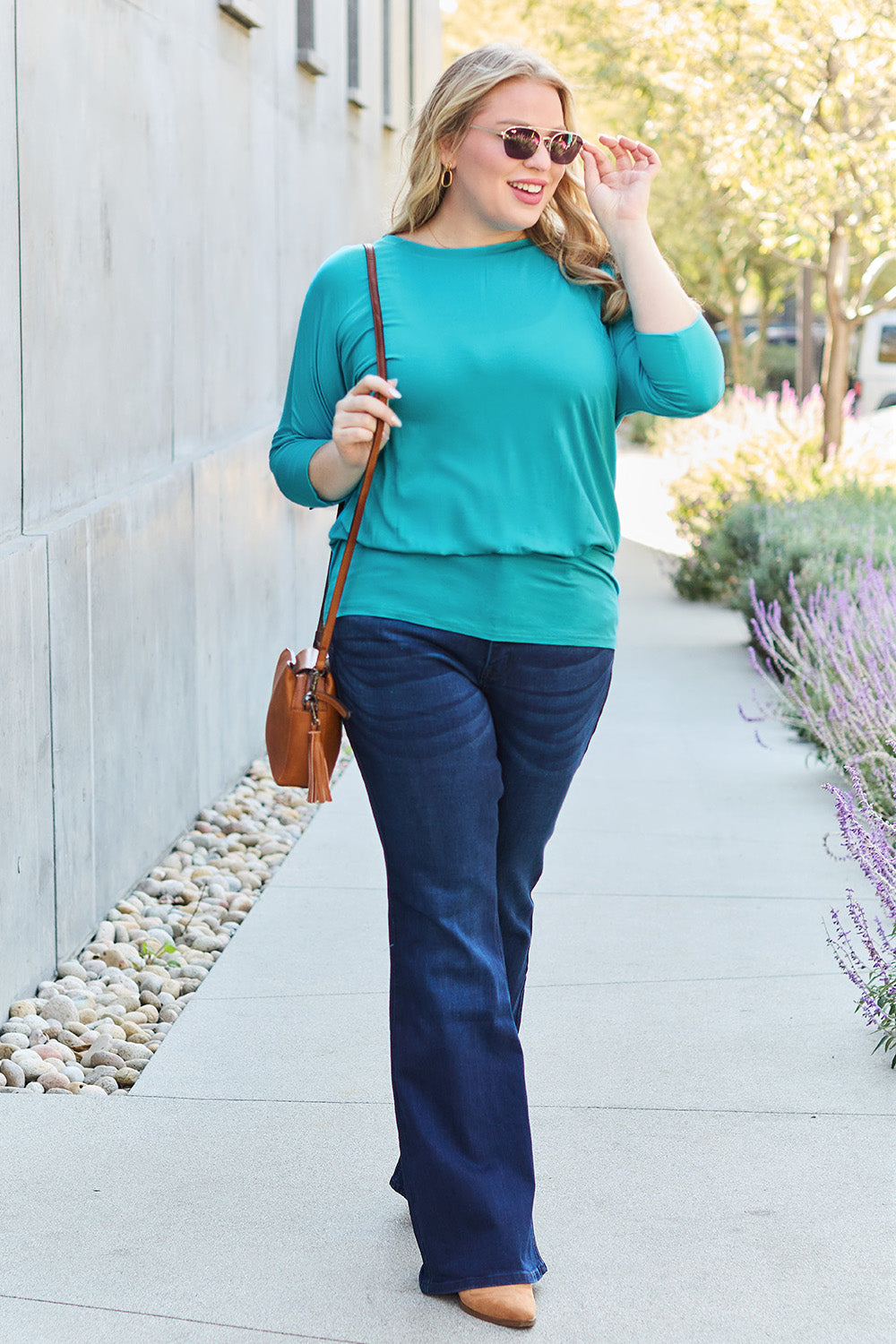 ShopBasicbae Basic Bae full-size round neck batwing sleeve top displayed on a hanger, featuring a relaxed fit and soft fabric.