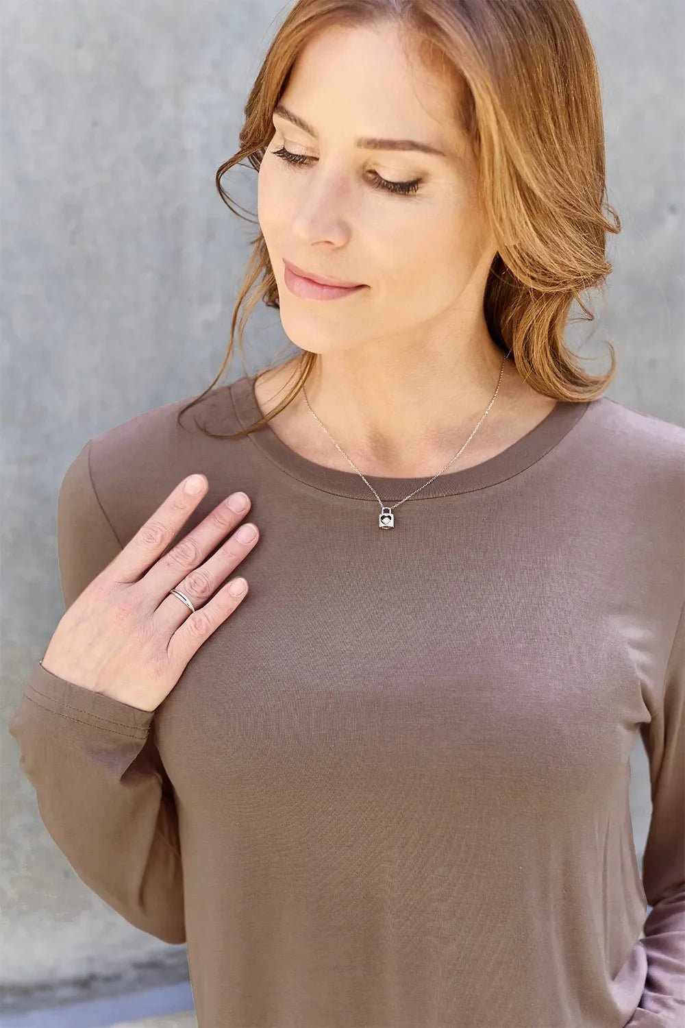 Women's round neck long sleeve top by ShopBasicbae, shown in a casual fit with soft fabric and long sleeves.