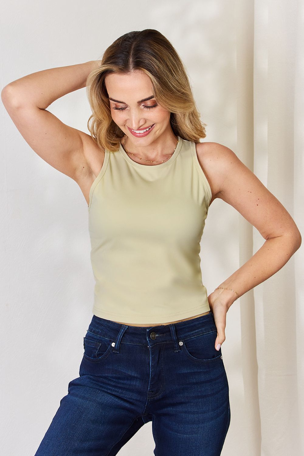 ShopBasicbae Basic Bae slim tank top with round neckline, fitted design, and sleeveless style in a solid color.