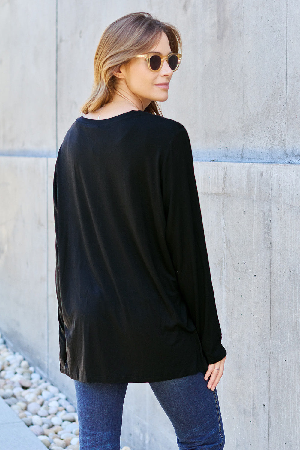 ShopBasicbae Basic Bae full size V-neck long sleeve top, navy blue, soft fabric, casual fit, displayed on a hanger.