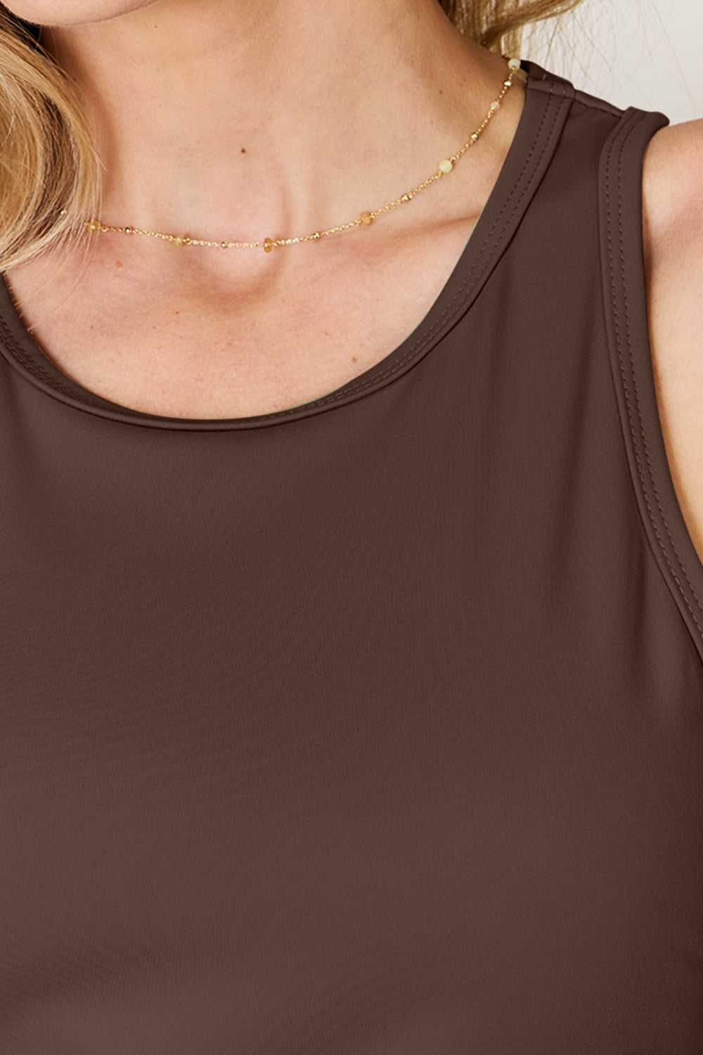 ShopBasicbae Basic Bae full-size round neck racerback tank top in soft fabric, shown on a mannequin with a relaxed fit.