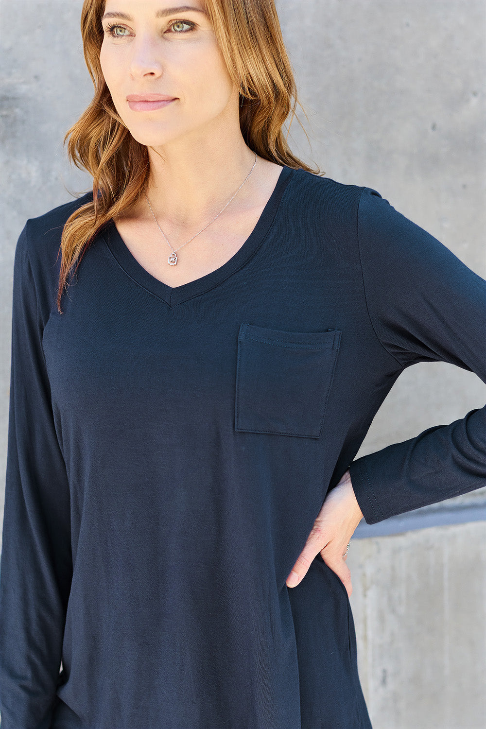 ShopBasicbae Basic Bae long sleeve V-neck top in neutral color, featuring a relaxed fit and soft fabric for everyday wear.