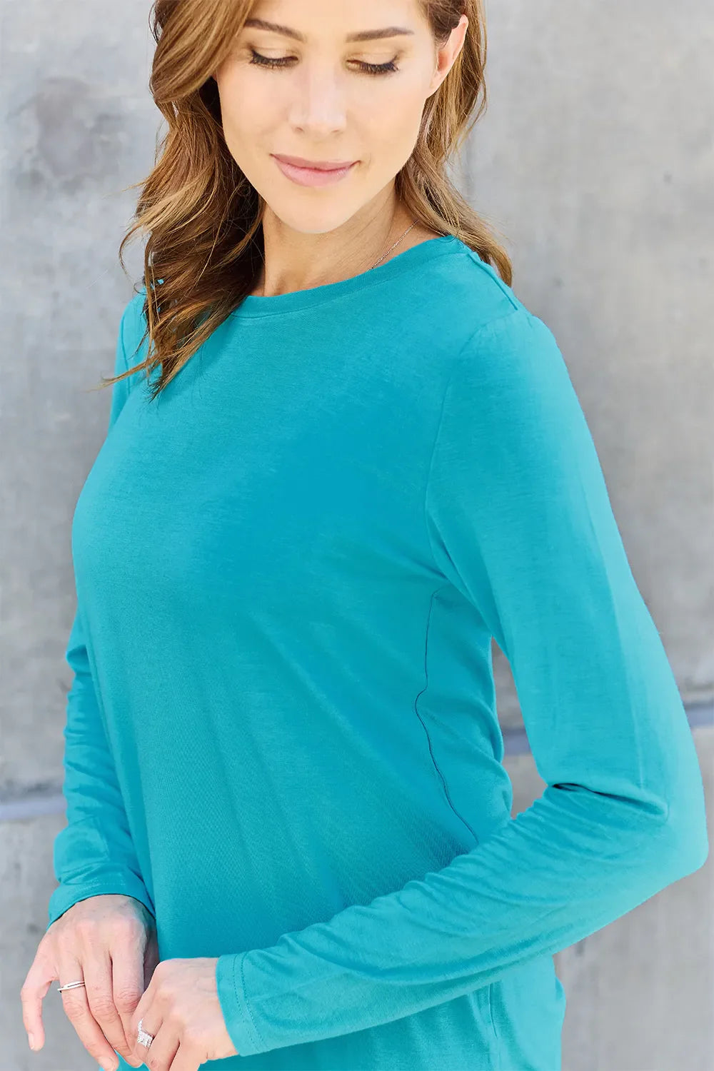 Women's long sleeve round neck top by ShopBasicbae, soft fabric, fitted style, in a neutral color, shown on a model.