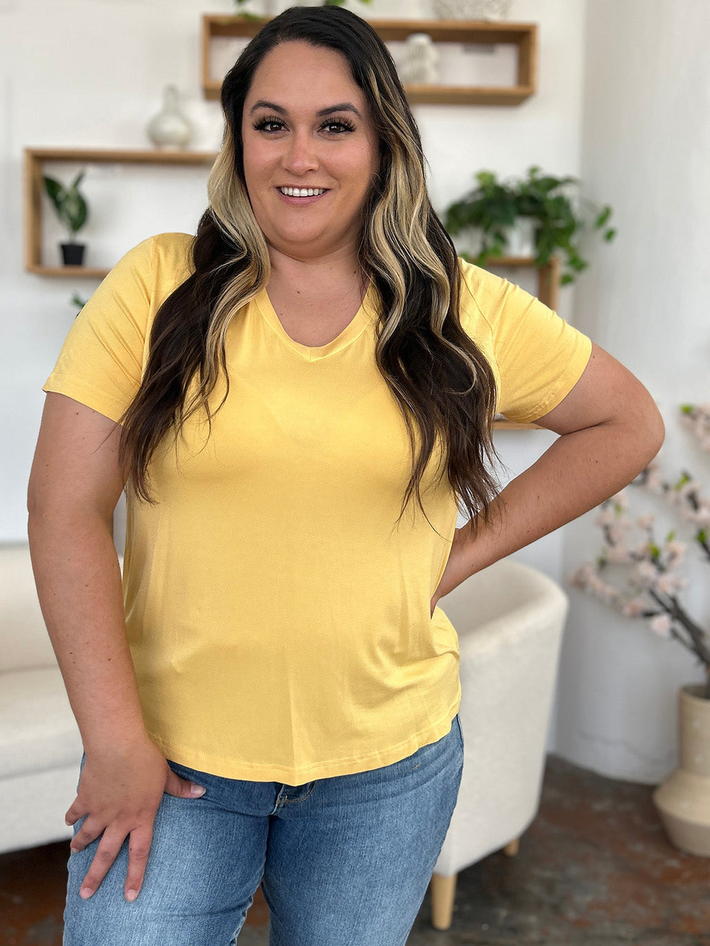 ShopBasicbae bamboo full size V-neck high-low T-shirt, beige color, casual tops with a relaxed fit and stylish design.