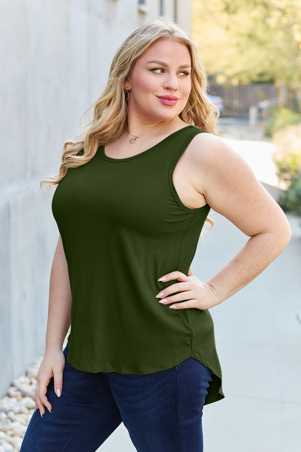 ShopBasicbae Basic Bae full-size round neck curved hem tank top, casual sleeveless top with a relaxed fit and curved hem design.