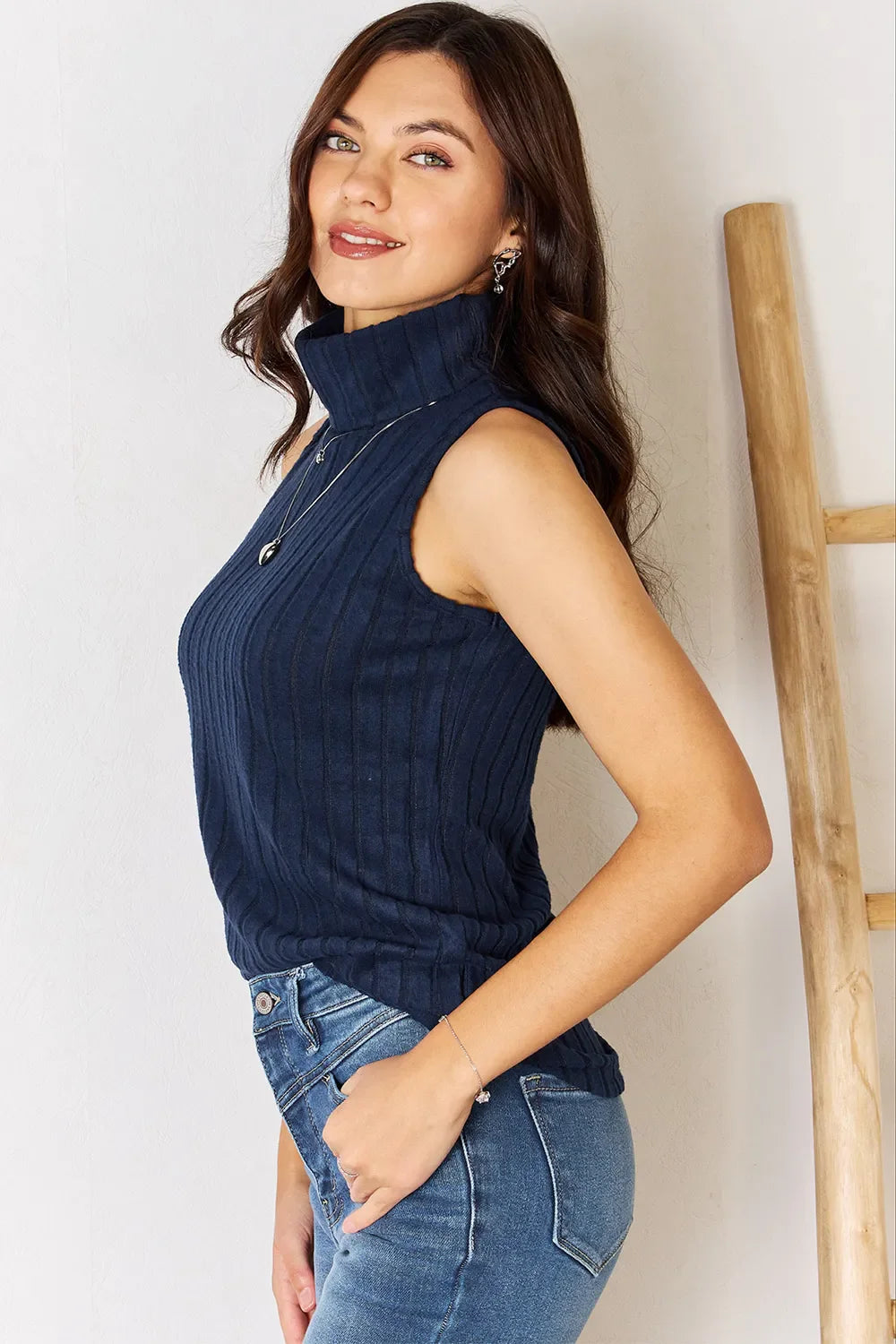 ShopBasicbae basic full size ribbed turtleneck tank top displayed on a hanger, showcasing its fitted ribbed design and turtleneck style.