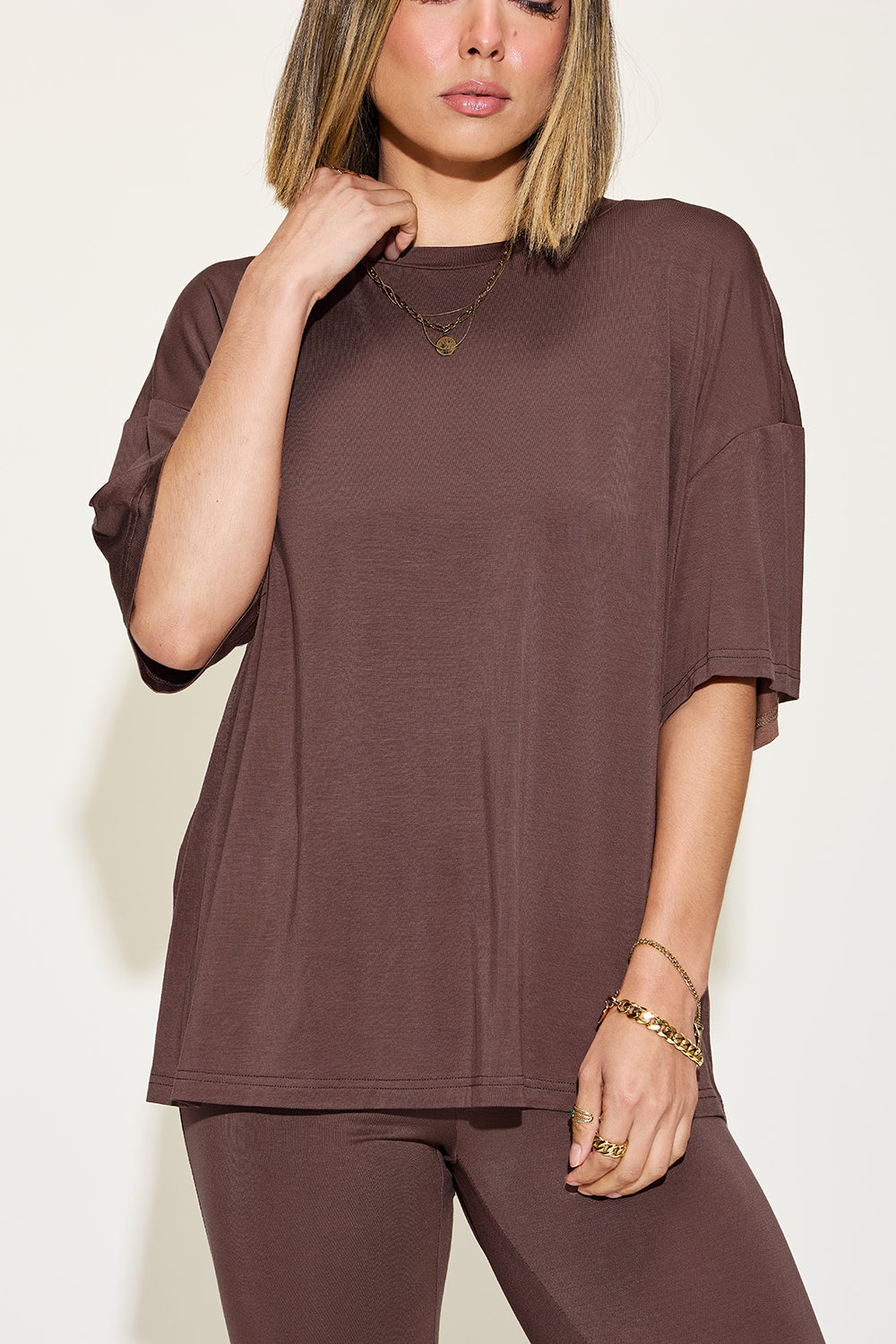 ShopBasicbae bamboo drop shoulder t-shirt and flare pants set, featuring a relaxed fit with natural bamboo fabric in neutral tones.