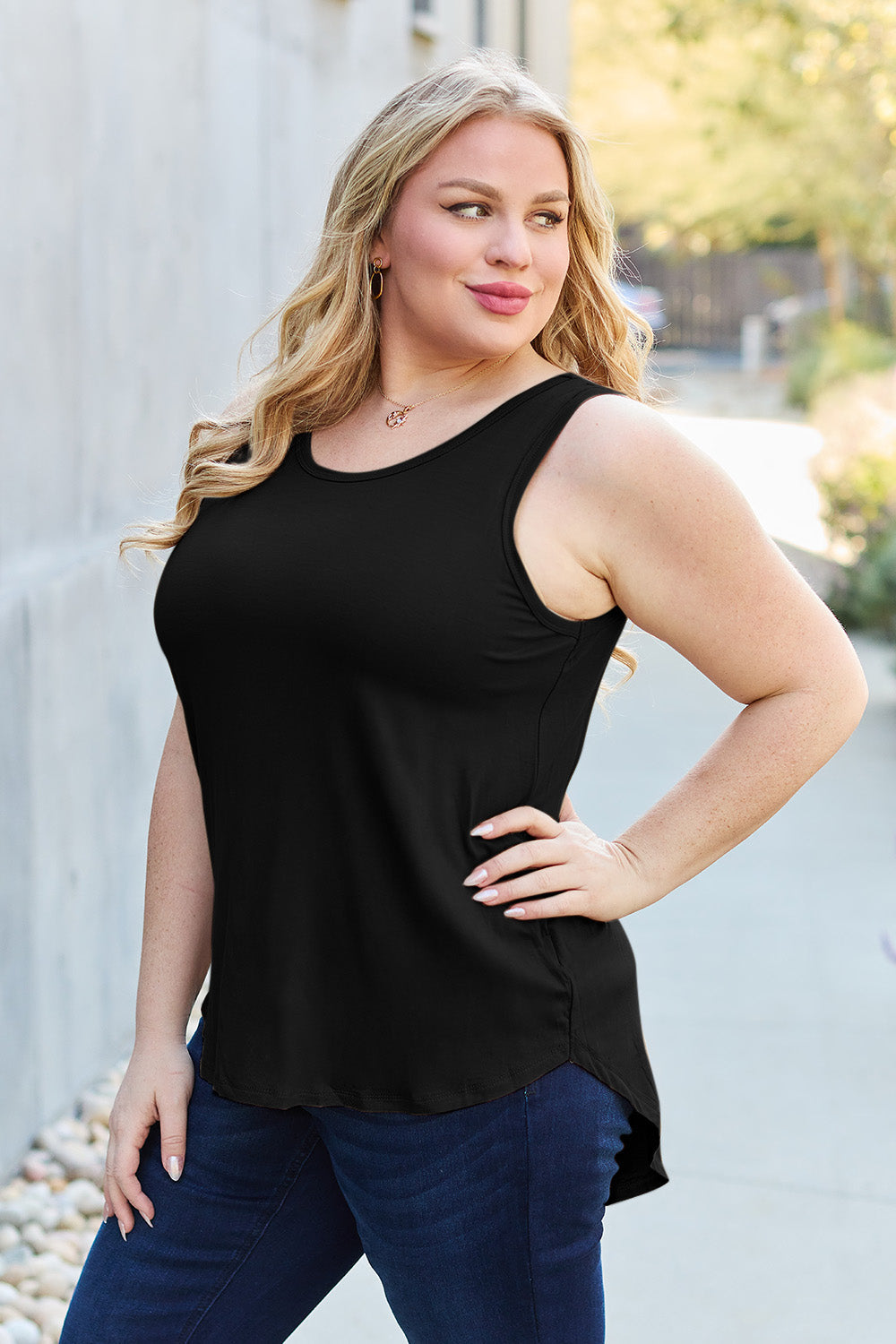 ShopBasicbae Basic Bae full size round neck curved hem tank top with sleeveless design and relaxed fit, shown on a hanger.