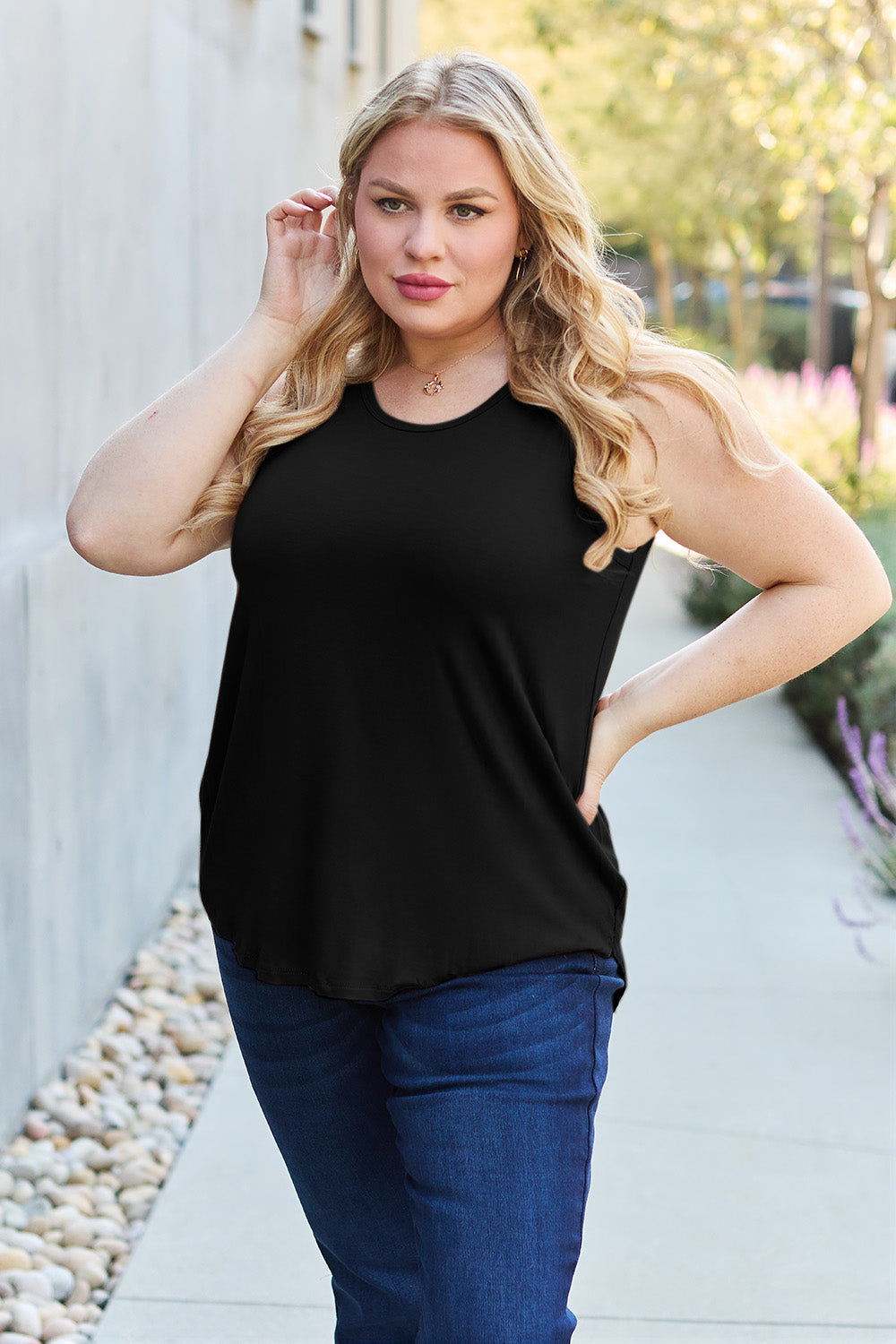 ShopBasicbae Basic Bae full-size round neck curved hem tank top, featuring a relaxed fit and sleeveless design.