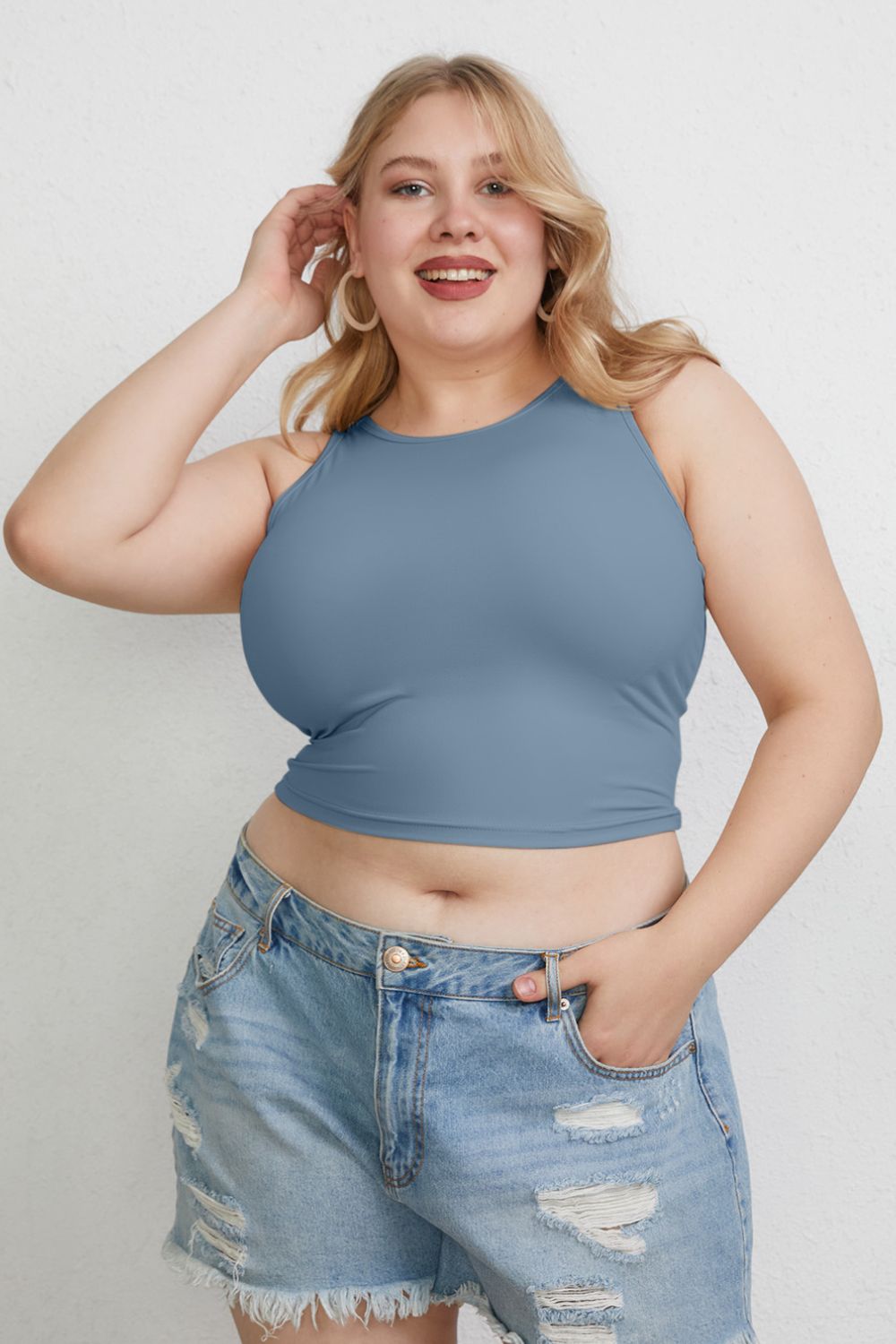 ShopBasicbae Basic Bae full size round neck slim tank top displayed on a hanger, showcasing its fit and simple design.